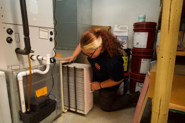 Tasha Fuels & Propane HVAC technician doing furnace maintenance