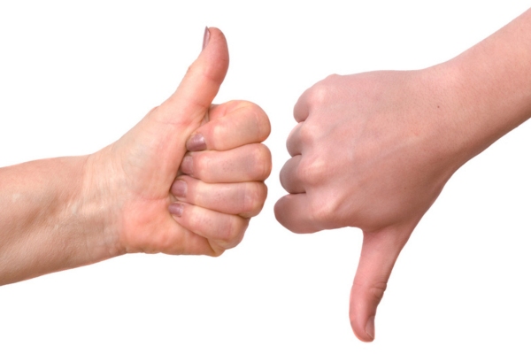 woman's hands making thumbs up and down depicting advantages and disadvantages of boiler